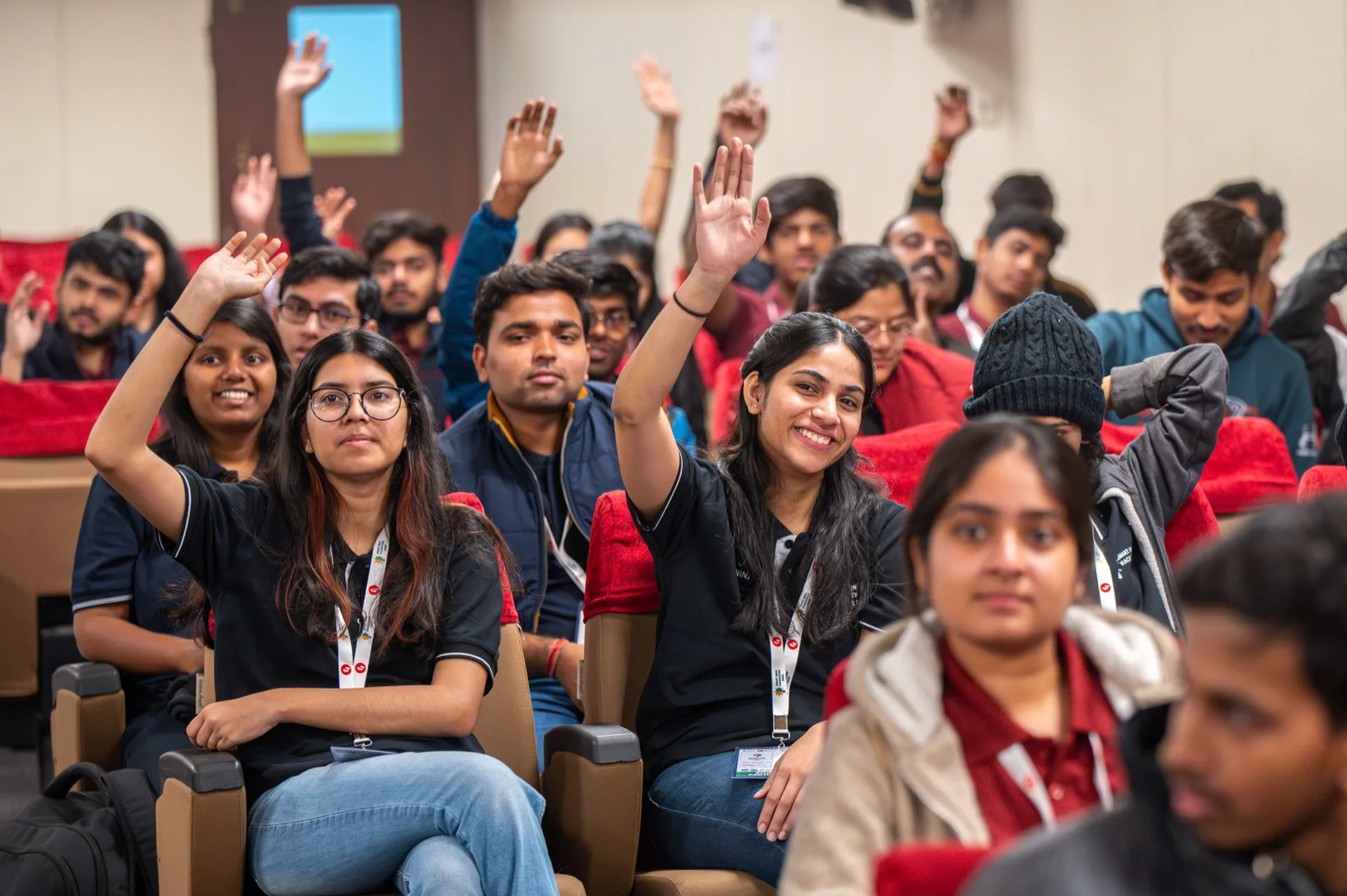 Indian students raising hands at a tech workshop